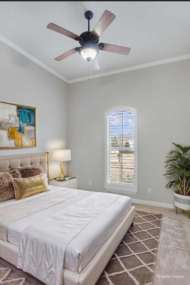 carpeted bedroom featuring ornamental molding, ceiling fan, and baseboards