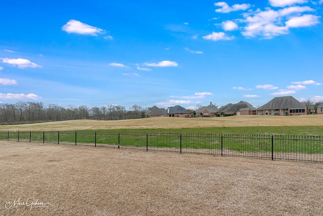 view of yard with a rural view and fence