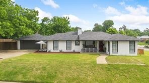 single story home with a garage, concrete driveway, and a front lawn