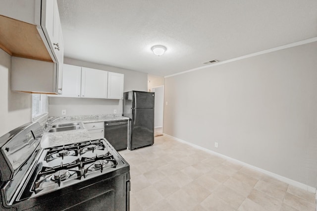 kitchen with visible vents, white cabinets, light countertops, black appliances, and a sink