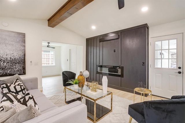 living area with light wood-style floors, recessed lighting, lofted ceiling with beams, and a ceiling fan