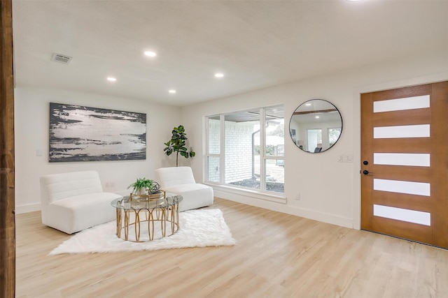 interior space with light wood-style floors, recessed lighting, visible vents, and baseboards