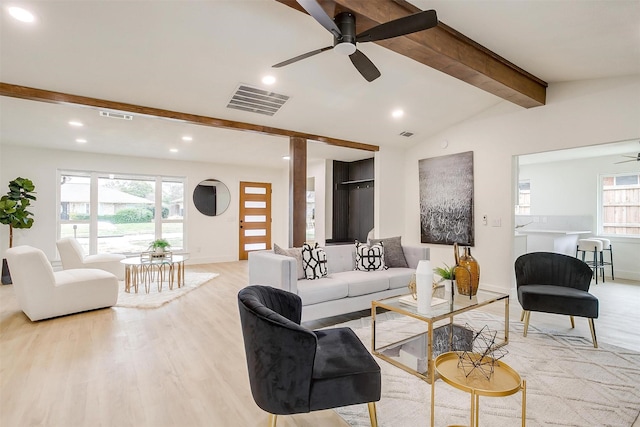 living area with visible vents, vaulted ceiling with beams, light wood-style flooring, and ceiling fan