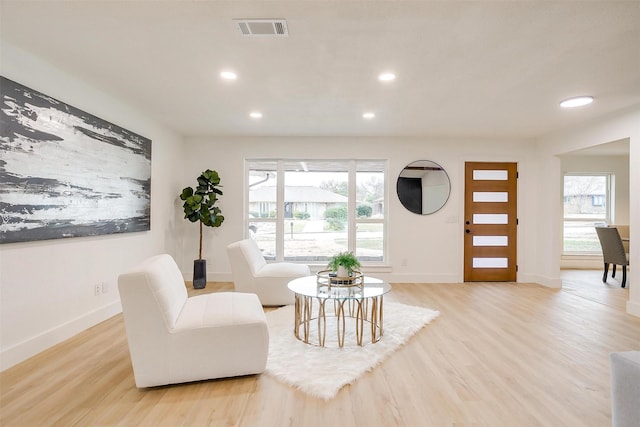 sitting room with light wood-style flooring, recessed lighting, visible vents, and baseboards