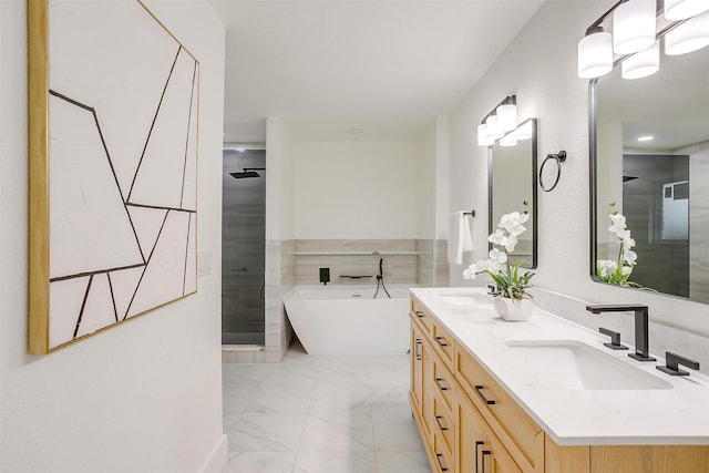 bathroom with marble finish floor, double vanity, a freestanding bath, a sink, and a shower stall