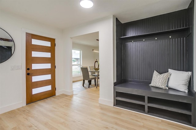 mudroom with light wood finished floors and baseboards