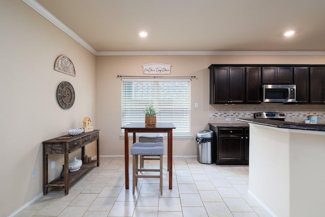 kitchen featuring dark brown cabinetry, stainless steel appliances, baseboards, ornamental molding, and backsplash