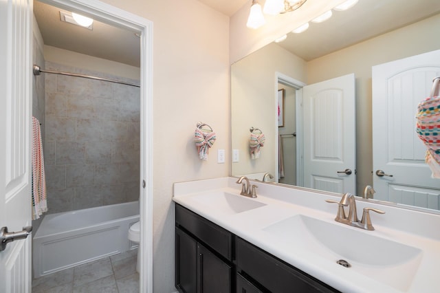 full bathroom featuring tile patterned floors, a sink, toilet, and double vanity