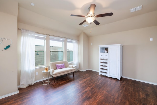 unfurnished room with visible vents, vaulted ceiling, and dark wood-type flooring