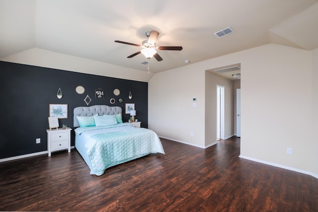 bedroom featuring baseboards, visible vents, vaulted ceiling, and dark wood-type flooring