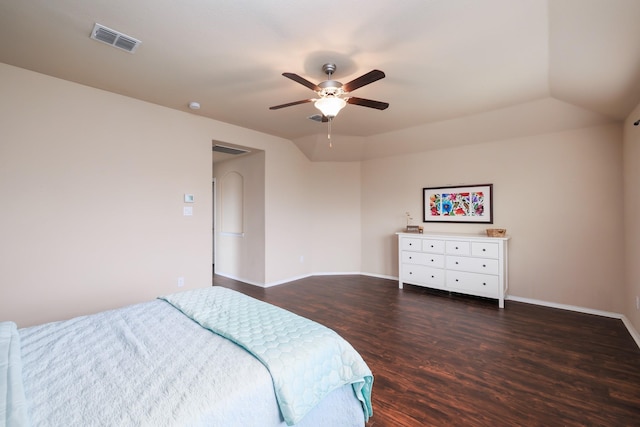 bedroom featuring baseboards, visible vents, a ceiling fan, dark wood-style flooring, and vaulted ceiling