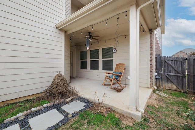 view of patio with a ceiling fan, a gate, and fence