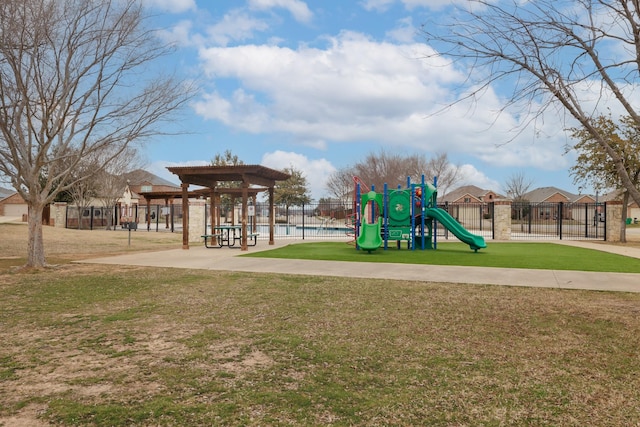 community play area with a yard and fence