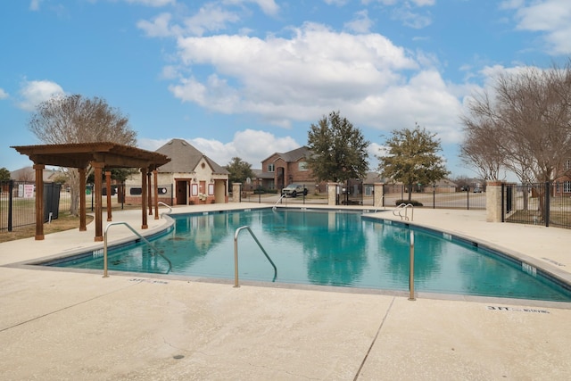 pool with a patio, fence, and a pergola