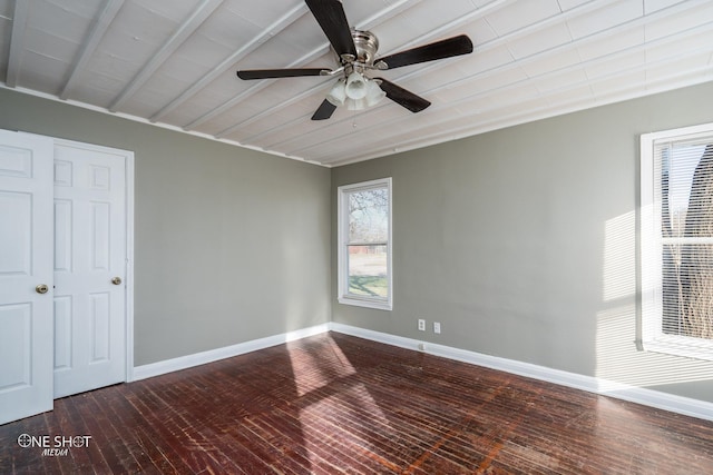 unfurnished room featuring ceiling fan, wood finished floors, and baseboards