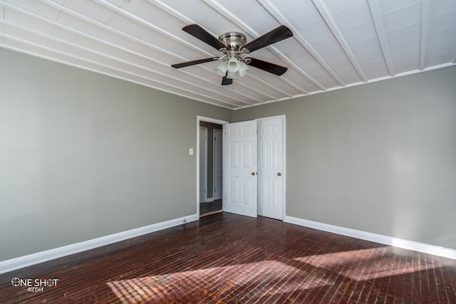 unfurnished bedroom featuring a ceiling fan, baseboards, and dark wood-type flooring