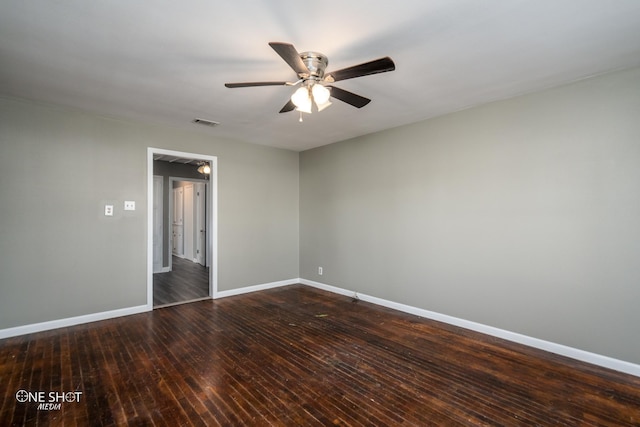 unfurnished room with a ceiling fan, dark wood-style flooring, visible vents, and baseboards