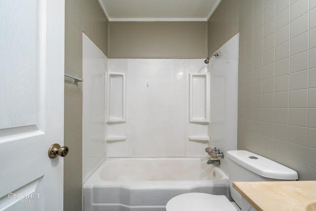 bathroom with toilet, shower / bathing tub combination, tile walls, and vanity