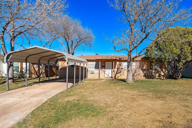 view of front facade with a front yard, concrete driveway, and a detached carport