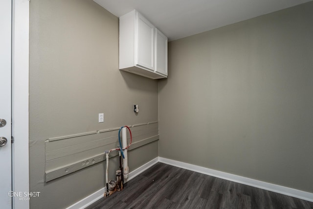 laundry area with dark wood-style floors, cabinet space, and baseboards