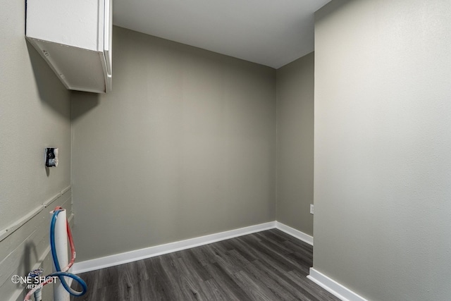 laundry area featuring baseboards and dark wood-style flooring