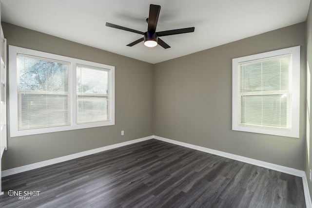 unfurnished room with ceiling fan, dark wood-style flooring, and baseboards