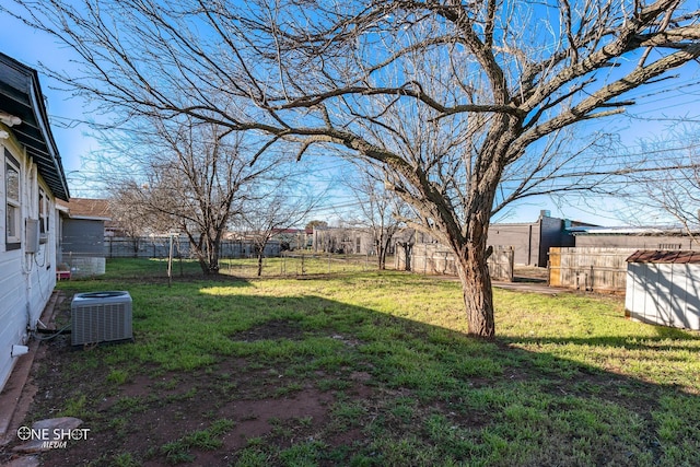 view of yard with central AC unit and a fenced backyard