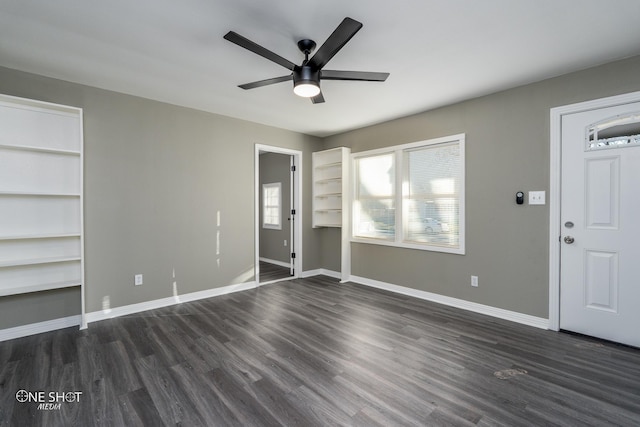 entryway featuring baseboards, dark wood finished floors, and a ceiling fan