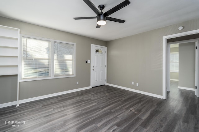 foyer featuring dark wood-style floors, a ceiling fan, and baseboards