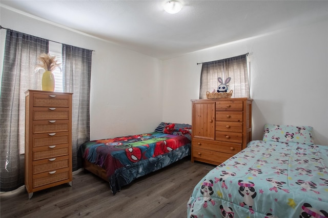 bedroom with dark wood-style floors