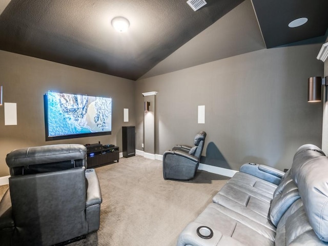 cinema room featuring baseboards, light carpet, visible vents, and vaulted ceiling