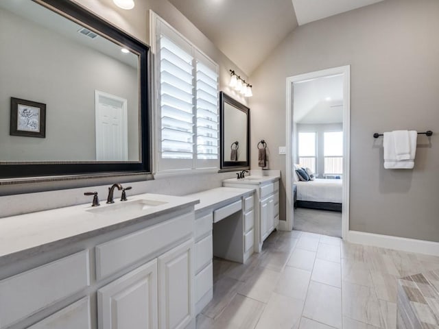 full bathroom with connected bathroom, visible vents, vanity, baseboards, and lofted ceiling