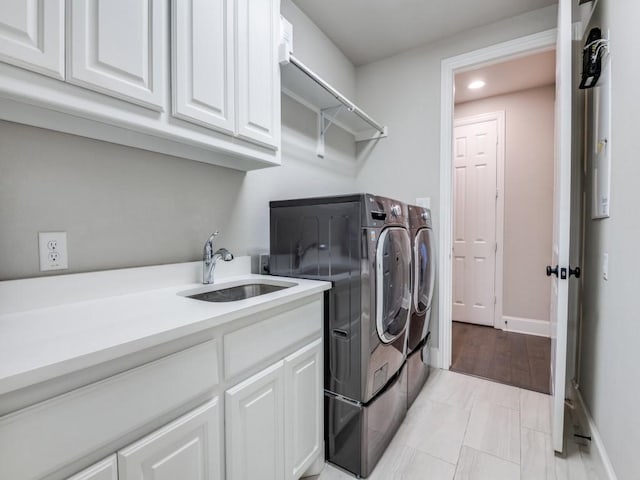 laundry room featuring washer and dryer, baseboards, recessed lighting, a sink, and cabinet space