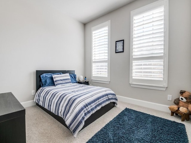 bedroom with baseboards and carpet flooring