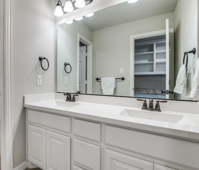 full bathroom featuring double vanity and a sink