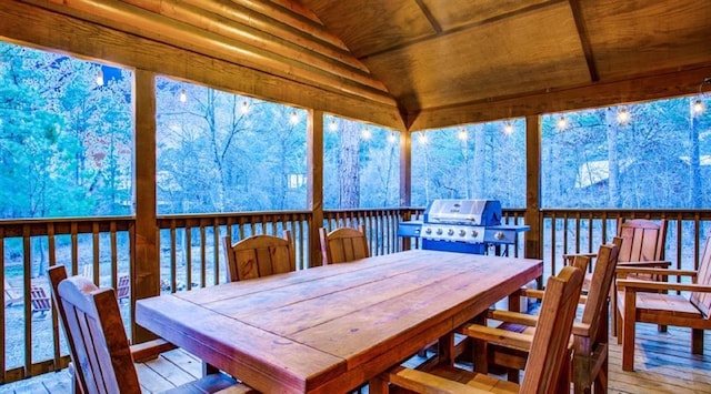 sunroom featuring lofted ceiling and wooden ceiling