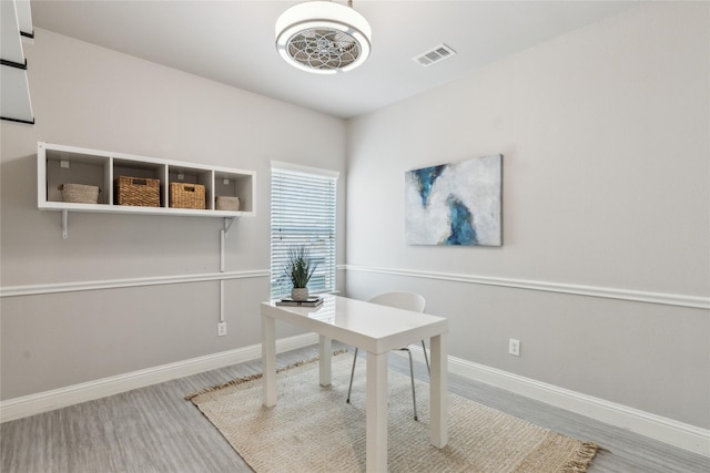 office space featuring visible vents, baseboards, and wood finished floors