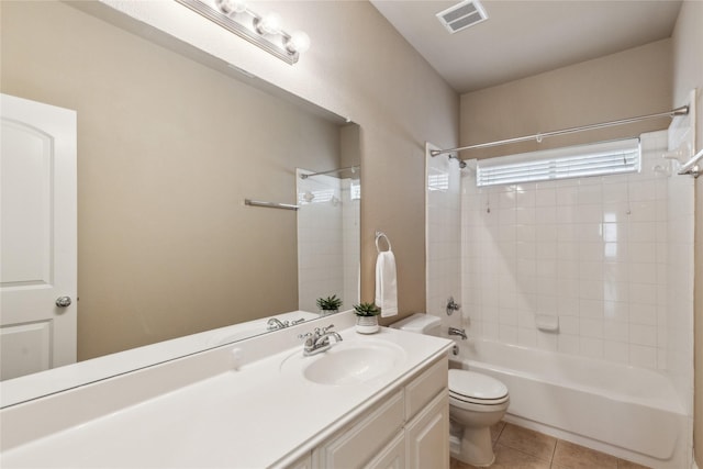 bathroom featuring tile patterned flooring, toilet, visible vents, vanity, and bathing tub / shower combination