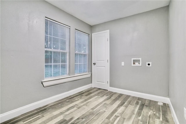 laundry area featuring washer hookup, electric dryer hookup, light wood-type flooring, laundry area, and baseboards