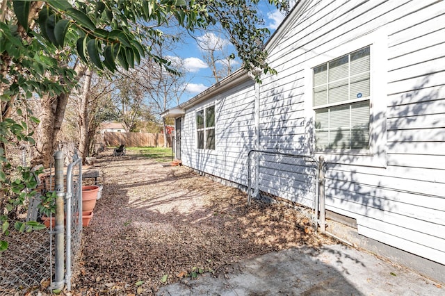 view of home's exterior with fence