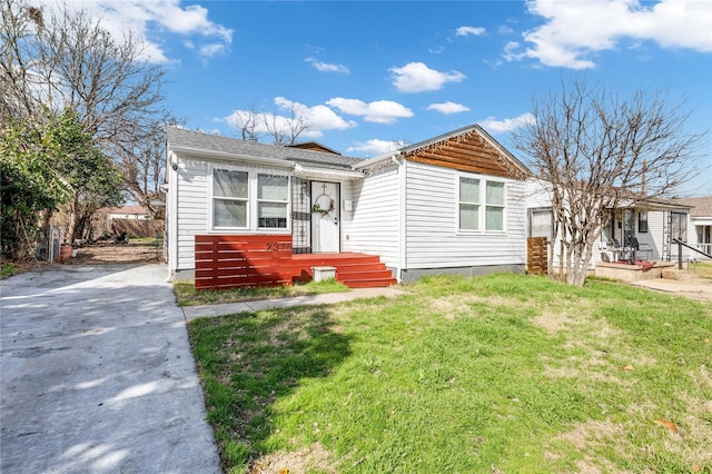 bungalow-style house featuring a front yard