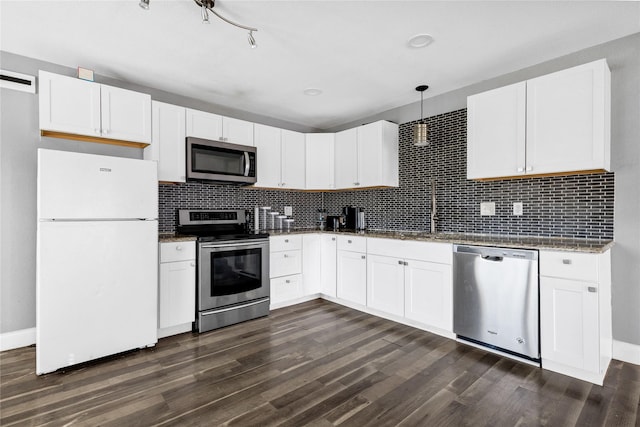 kitchen featuring stainless steel appliances, pendant lighting, white cabinetry, and a sink