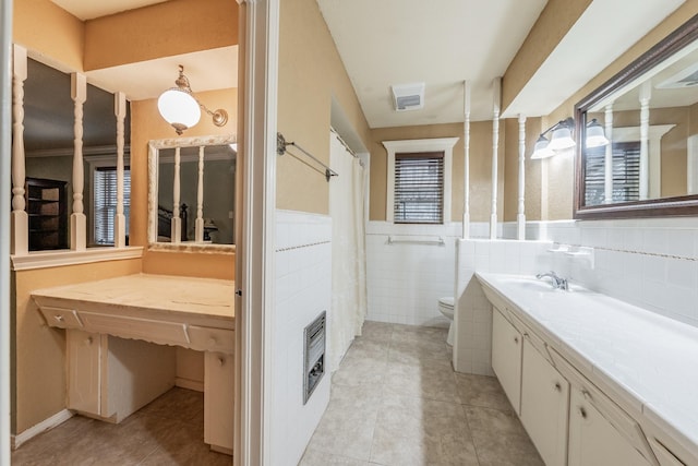 full bathroom featuring tile patterned flooring, a wainscoted wall, vanity, and toilet