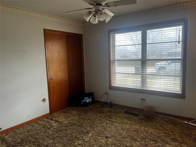 unfurnished bedroom with a closet, visible vents, a ceiling fan, carpet flooring, and baseboards