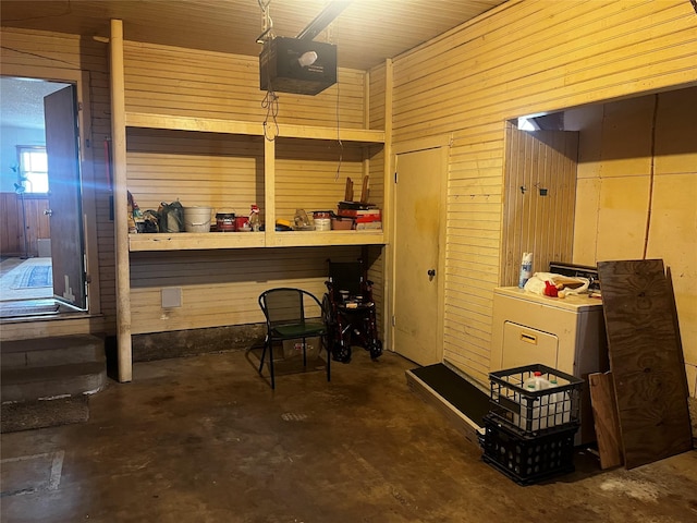 interior space featuring wooden walls and concrete flooring