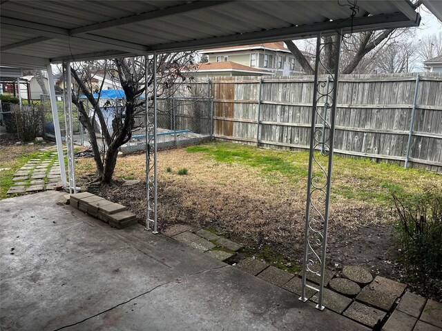 view of yard with fence and a patio