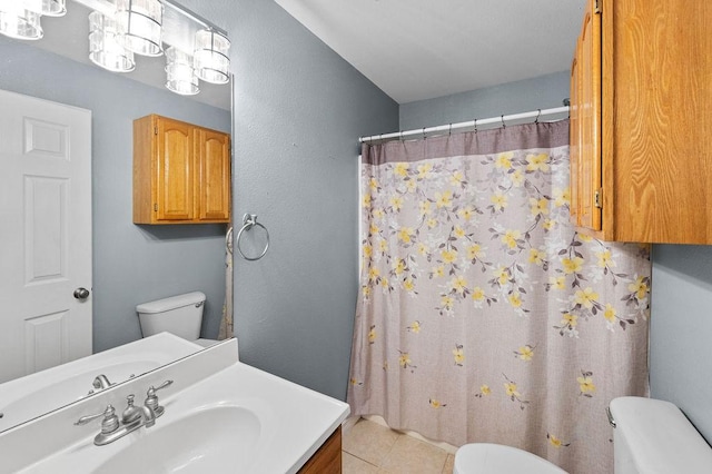 bathroom with toilet, tile patterned flooring, and vanity