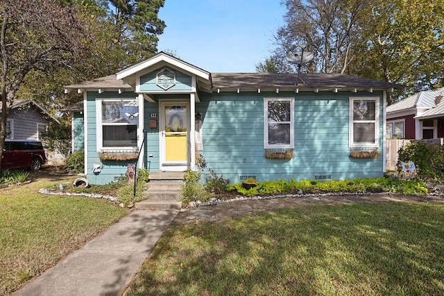 bungalow-style home featuring crawl space and a front yard