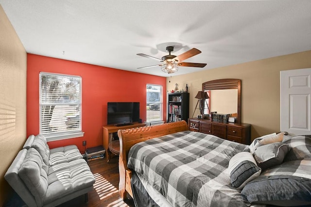 bedroom with dark wood-type flooring and ceiling fan