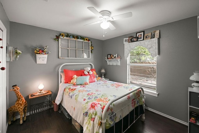 bedroom featuring dark wood-style floors, baseboards, and a ceiling fan